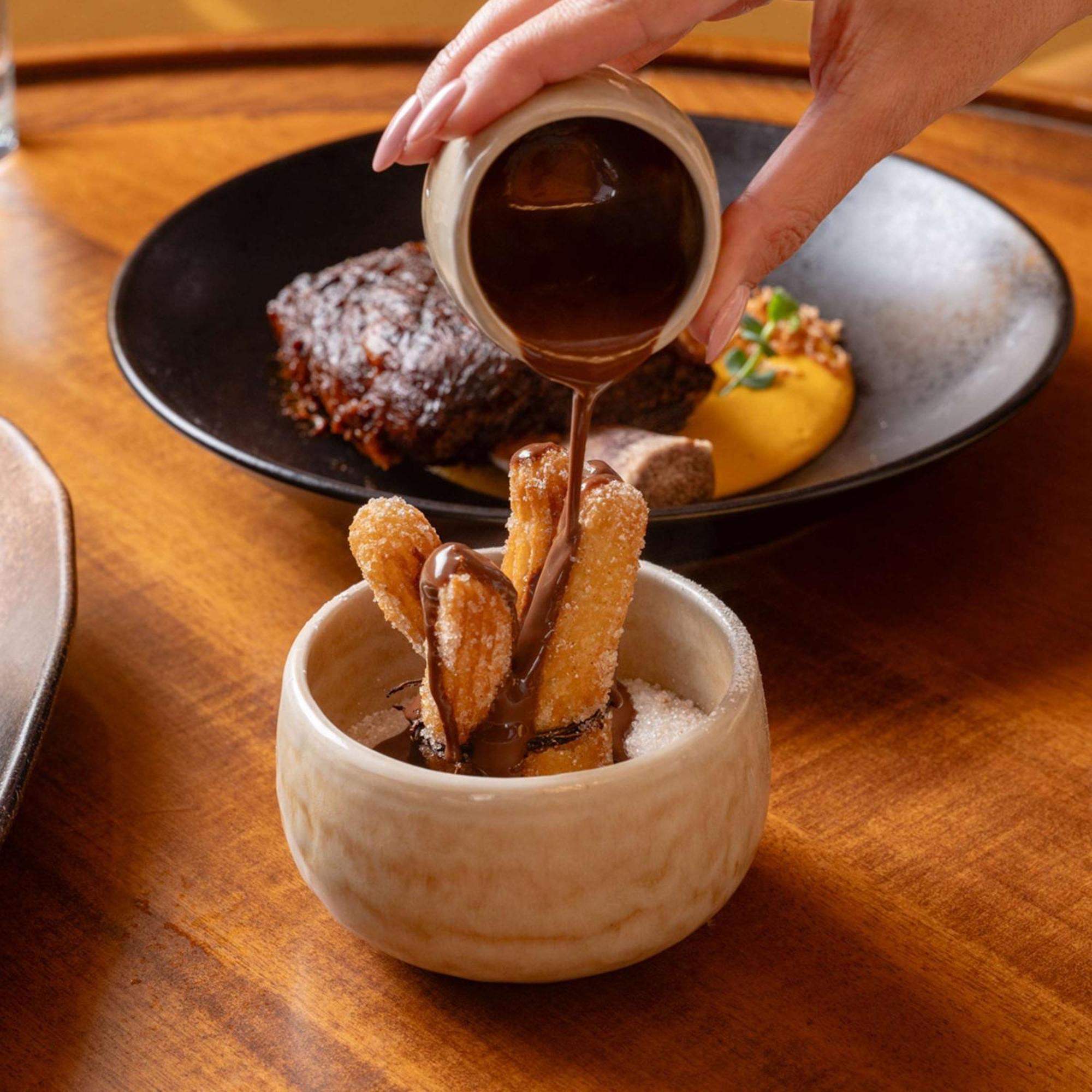 V Hotel Dubai, Curio Collection By Hilton Экстерьер фото Soy sauce being poured on tempura